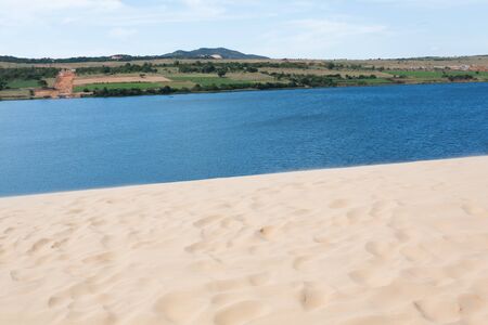 footprint on white sand dune desert and lake in Mui Ne, Vietnamの写真素材