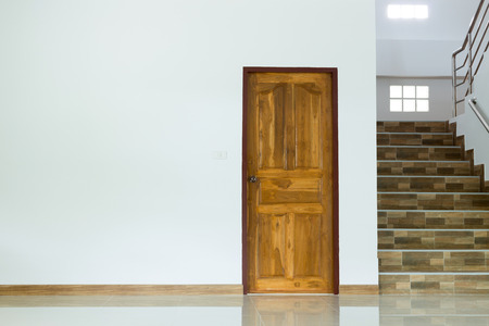 white empty room interior with wooden door and staircaseの写真素材