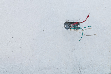electric wire on white cement wall in construction site industryの写真素材