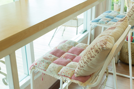 bar stool with pillow cushion flowers pattern interior decoration in cafeの写真素材