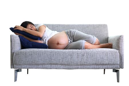 beautiful woman pregnant sleeping sweet dream on sofa furniture in home living room, image isolated on white backgroundの写真素材