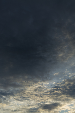monsoon weather dramatic moody rain storm sky with light in the darkness cloudyの写真素材