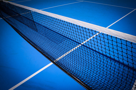 net on blue tennis court sport backgroundの写真素材