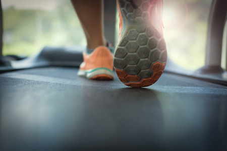 close-up footwear image, human jogging exercise on run treadmill machine cardio equipment at sport healthy club centerの写真素材