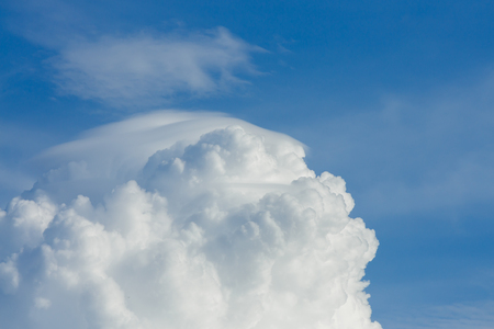 fluffy cloud above clear blue sky cloudy backgroundの写真素材