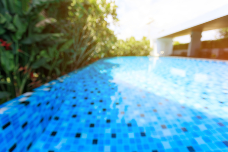 modern blue swimming pool around with landscaping green nature gardenの写真素材