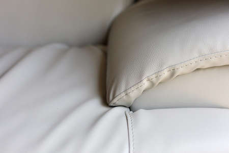 clean beige leather couch sofa furniture seat, upholstery surface seam stitched qualityの写真素材
