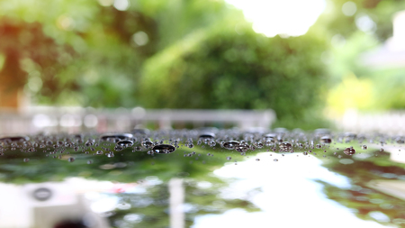 water rain droplet on black car with glass coating skin