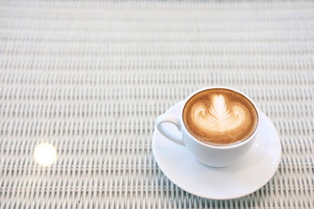 heart shape latte art of hot coffee drink tasty on white table in cafeの写真素材