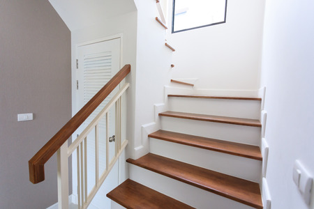 inside contemporary white modern house with wood staircaseの写真素材
