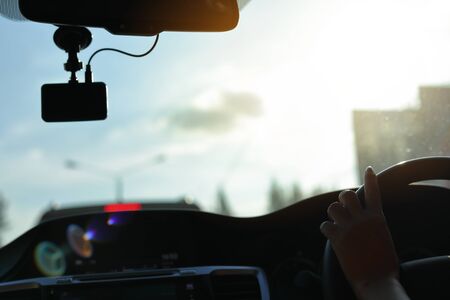 people driving car travel road trip with sun light on clear skyの写真素材