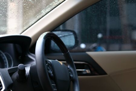 steering wheel drive control vehicle inside car with rainy dayの写真素材