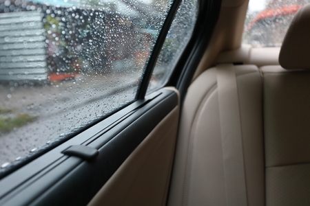 rain drop on window vehicle car, travel road trips in the rainy dayの写真素材