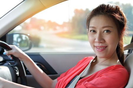 beautiful asian woman driving car travel road trip, female portrait eye looking at camera