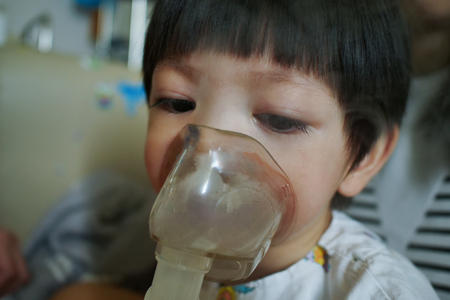 baby using nebulizer mask machineの写真素材