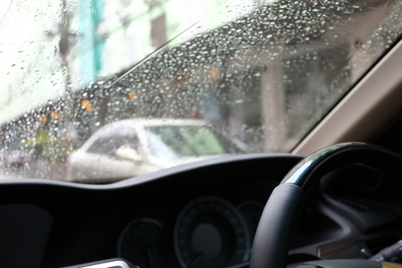 steering wheel drive control vehicle car with rain drop on windshieldの写真素材