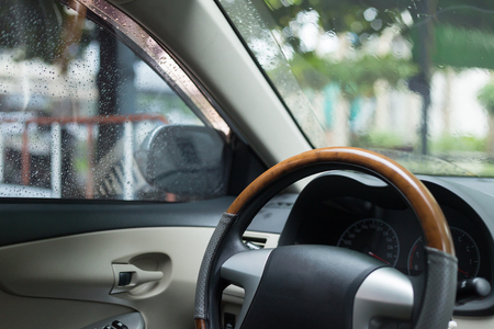closeup steering wheel inside modern car in the morning rainy dayの写真素材