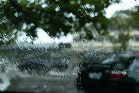 water rain drop on windshield of car driving on roadの写真素材