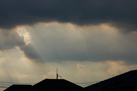 sunlight through cloud on dramatic sky after the rainの写真素材
