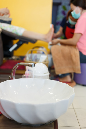 white basin in pedicure spa salonの写真素材