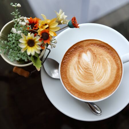 hot latte coffee drink put on table in cafeの写真素材