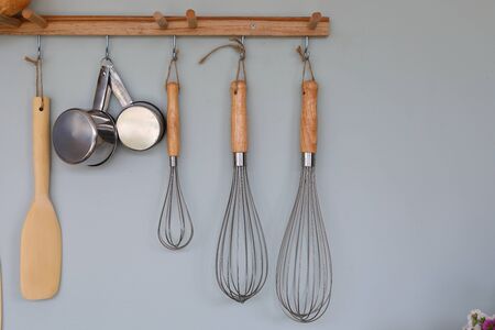 cooking kitchenware hanging on wall in kitchen room