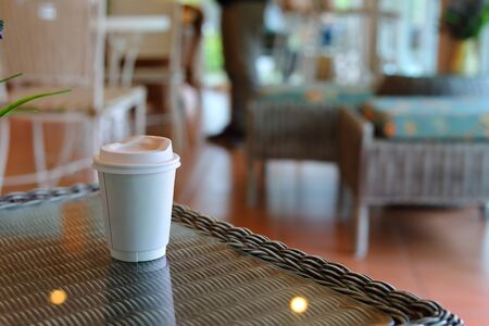 take away cup for hot coffee drink put on glass table in cafe shop