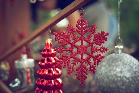 red christmas snowflake ornament hanging decoration in outdoor gardenの写真素材