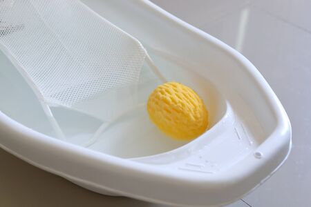 baby bathtub with support seat of newborn sitting in water and soft sponge