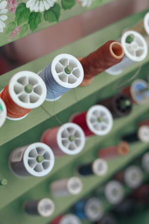 shelf of colorful thread set material for sewing embroidery