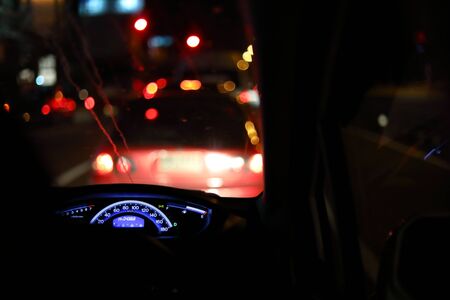 people driving car on night road, traffic jam in the city
