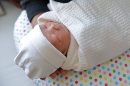 innocence face of cute baby newborn close eye sleeping in white blanket childhood