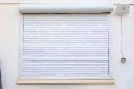 white window roller shutter closed security in modern houseの写真素材