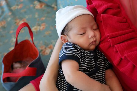asian baby so cute sleeping sweet dream on motherの写真素材