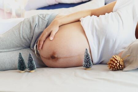 woman pregnant in merry christmas conceptの写真素材