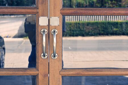 copper handle on antique door, design doorway with glass and old woodの写真素材