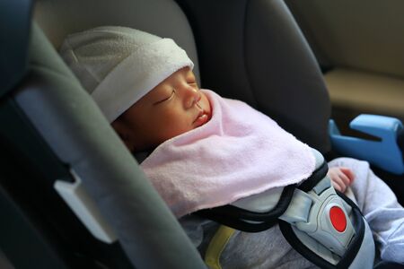 cute newborn baby sleeping in car seat safety belt lock protection drive road trip