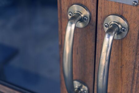copper handle on antique door, design doorway with glass and old woodの写真素材