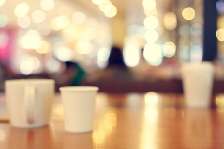 coffee cup on table inside cafe, image abstract blurred background