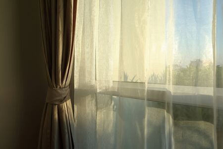 sunlight in morning day through white curtain on windowの写真素材