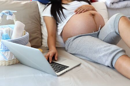 mother pregnancy working online in home office, pregnant mom typing keyboard laptop computer