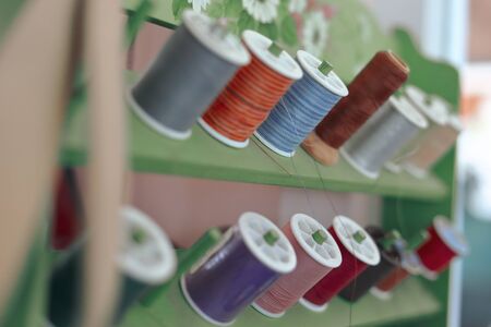 shelf of colorful thread set material for sewing embroidery