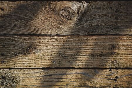light and shadow on wood barn wall plank texture background, top view of old wooden tableの写真素材