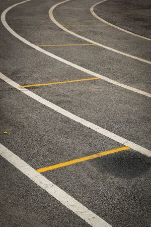 black tarmac asphalt of running track, athletic sport backgroundの写真素材