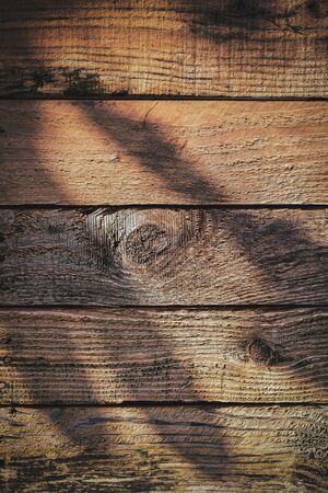 light and shadow on wood barn wall plank texture background, top view of old wooden table