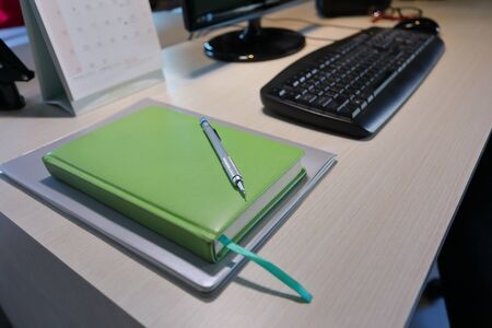 diary book and pen on desk of table work inside business home officeの写真素材