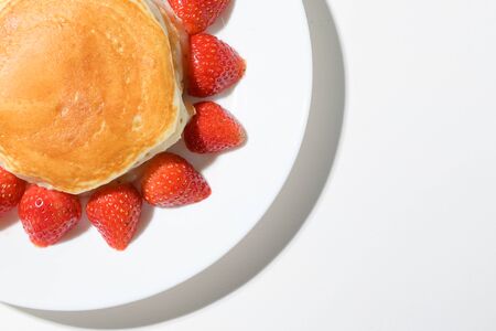 cute pancake strawberry with sun shape on white backgroundの写真素材