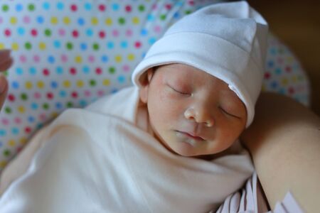 cute baby newborn sleeping sweet dream in mother arm embracing with love