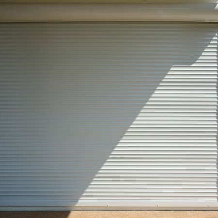 white roller shutter door closed security in modern houseの写真素材