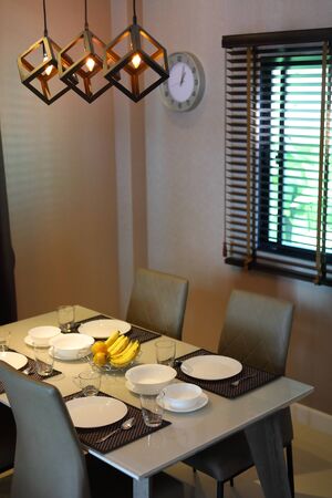 dish ware sets arrange on dining table inside eating room of modern home interior